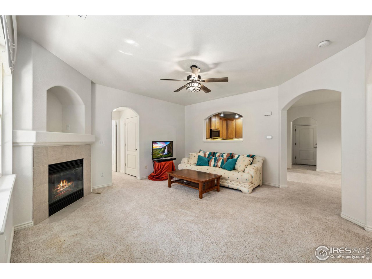 4672 West 20th Road, Unit 2212 Greeley, CO 80634 - Photo 10 of 40 Arched entries create an expansive feeling in the living room and a gas fireplace ensures a welcoming atmosphere.