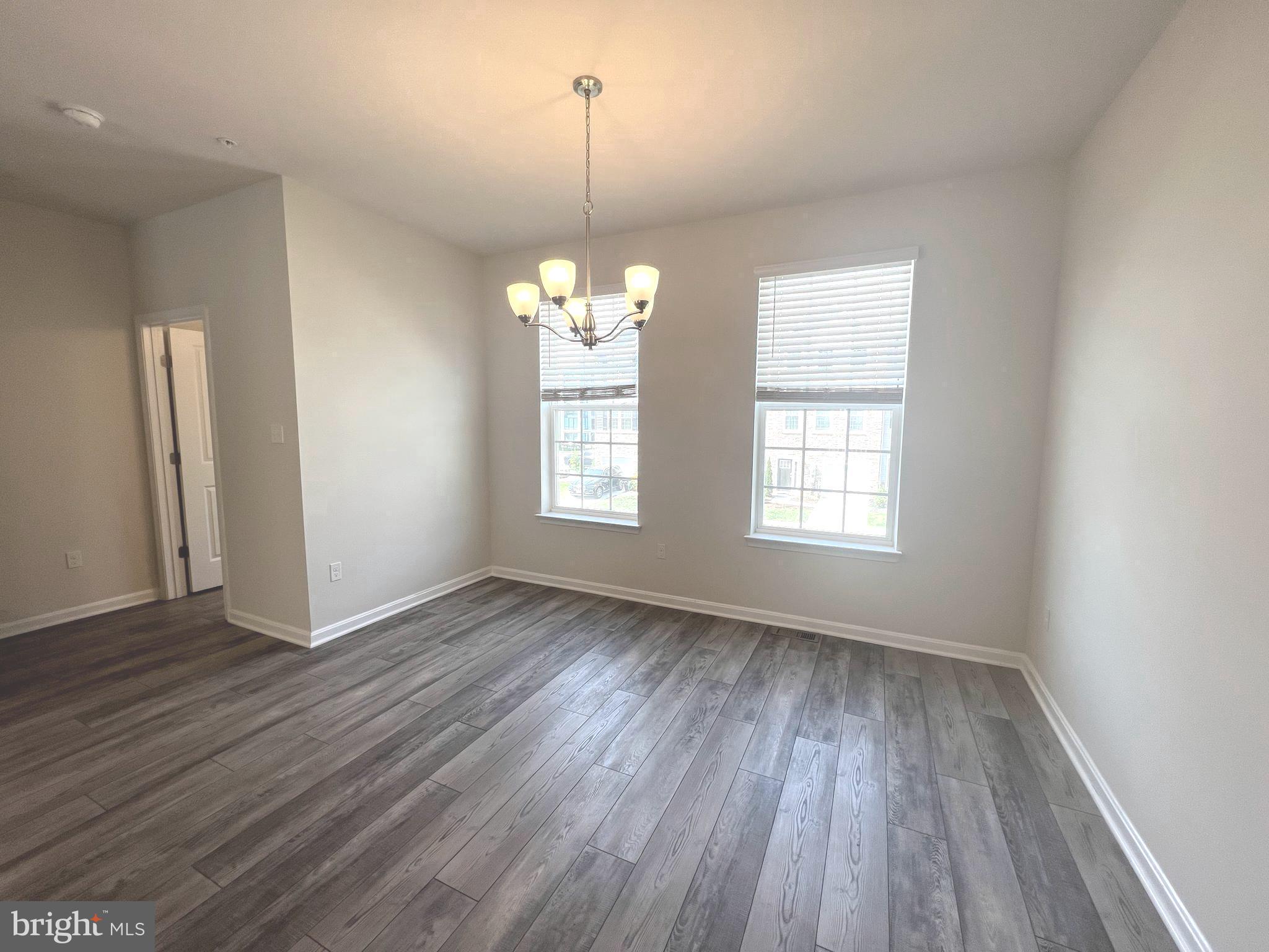 2013 Thornbrook Way Odenton, MD 21113 - Photo 4 of 17 an empty room with wooden floor and windows