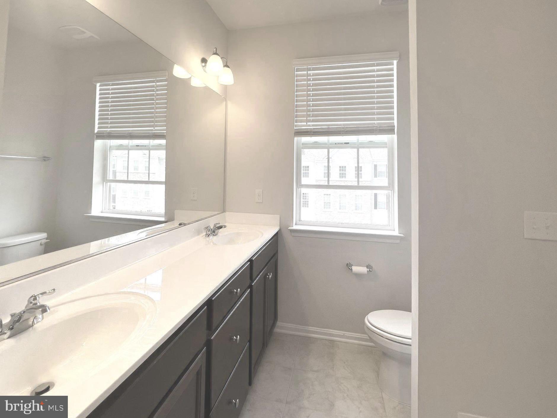 2013 Thornbrook Way Odenton, MD 21113 - Photo 10 of 17 a spacious bathroom with a granite countertop sink a toilet and a window