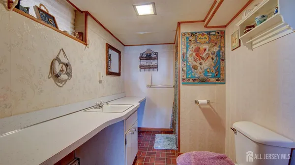a bathroom with a sink a toilet and shower curtain