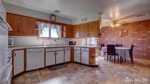 a kitchen with granite countertop a sink cabinets and window