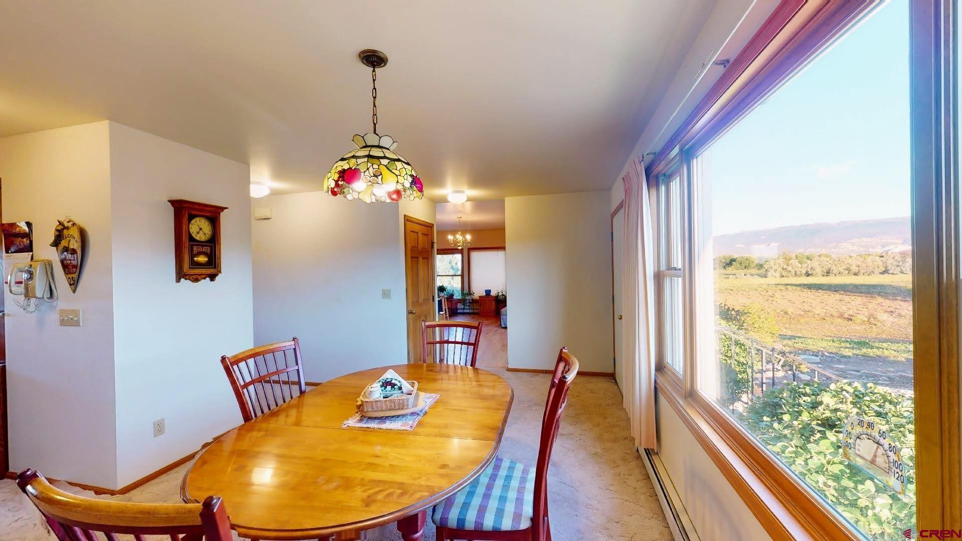 21669 Myers Road Orchard City, CO 81418 - Photo 12 of 35 a view of a dining room with furniture window and wooden floor