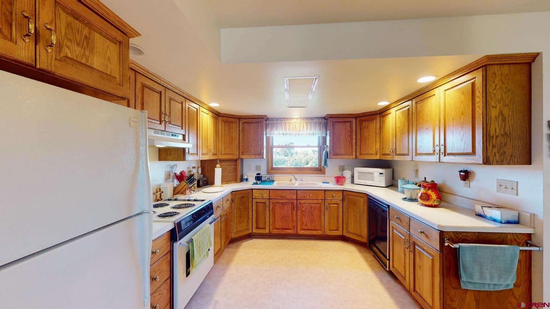 21669 Myers Road Orchard City, CO 81418 - Photo 13 of 35 a kitchen that has a sink and a stove in it