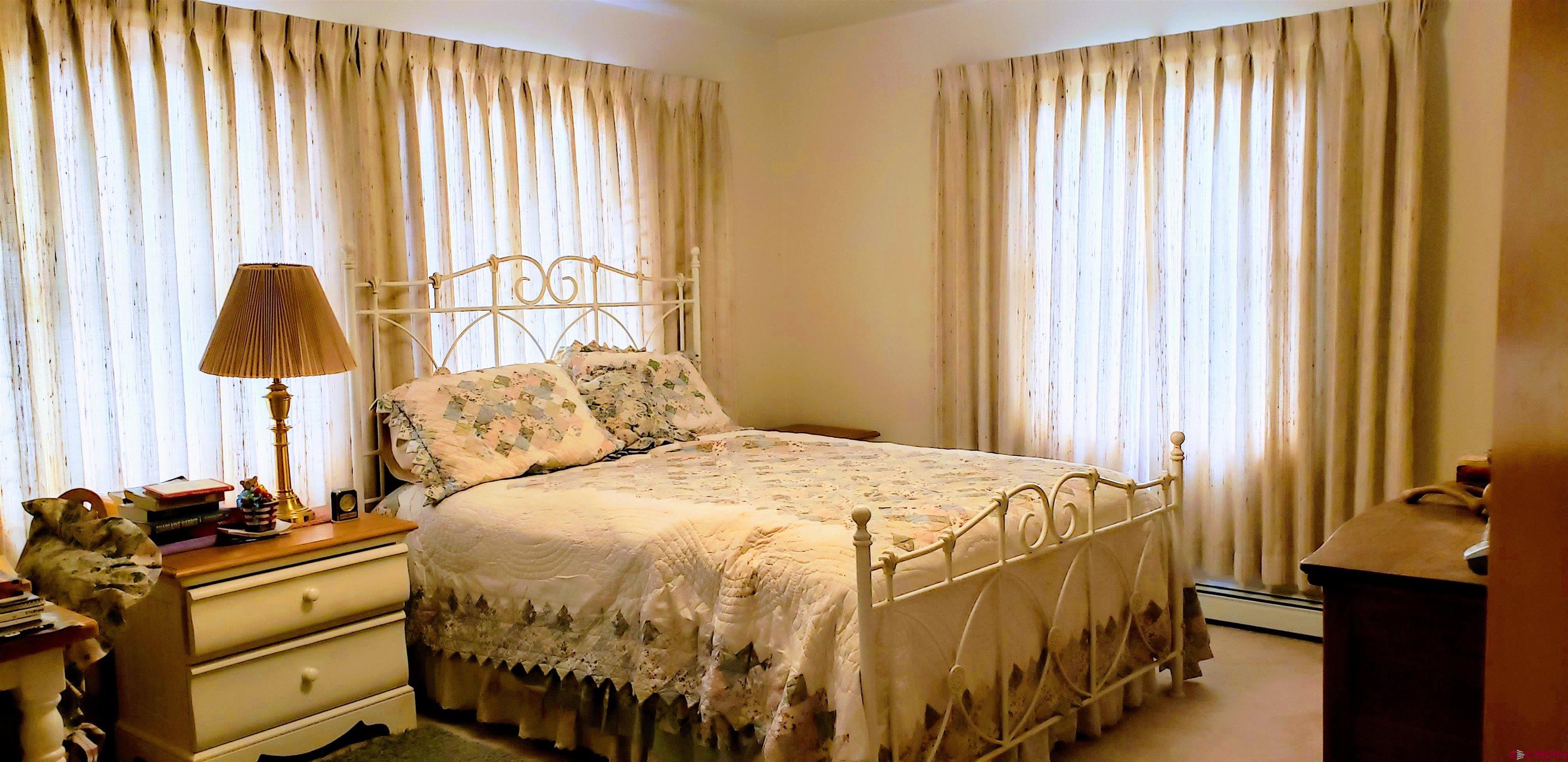 21669 Myers Road Orchard City, CO 81418 - Photo 15 of 35 a bedroom with a bed and a window