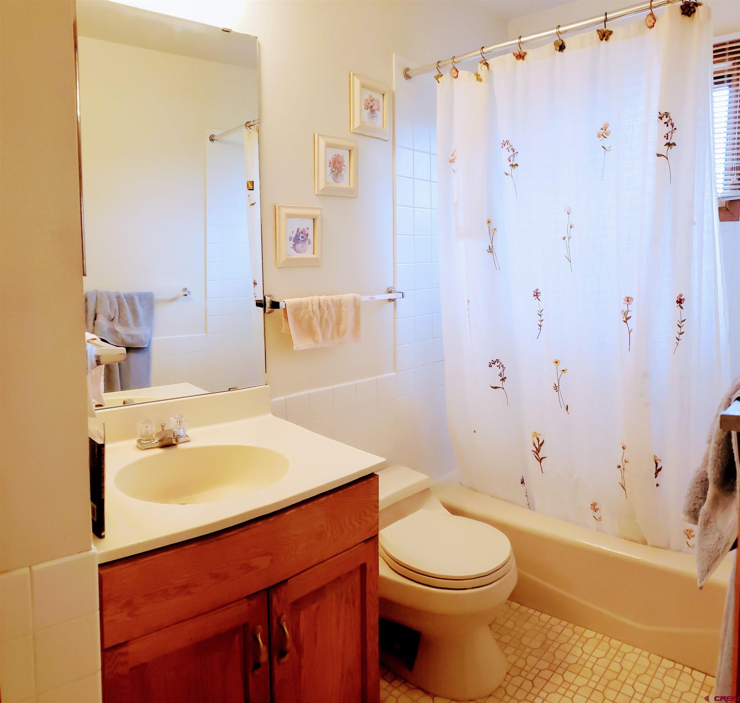 21669 Myers Road Orchard City, CO 81418 - Photo 16 of 35 a bathroom with a sink toilet and shower