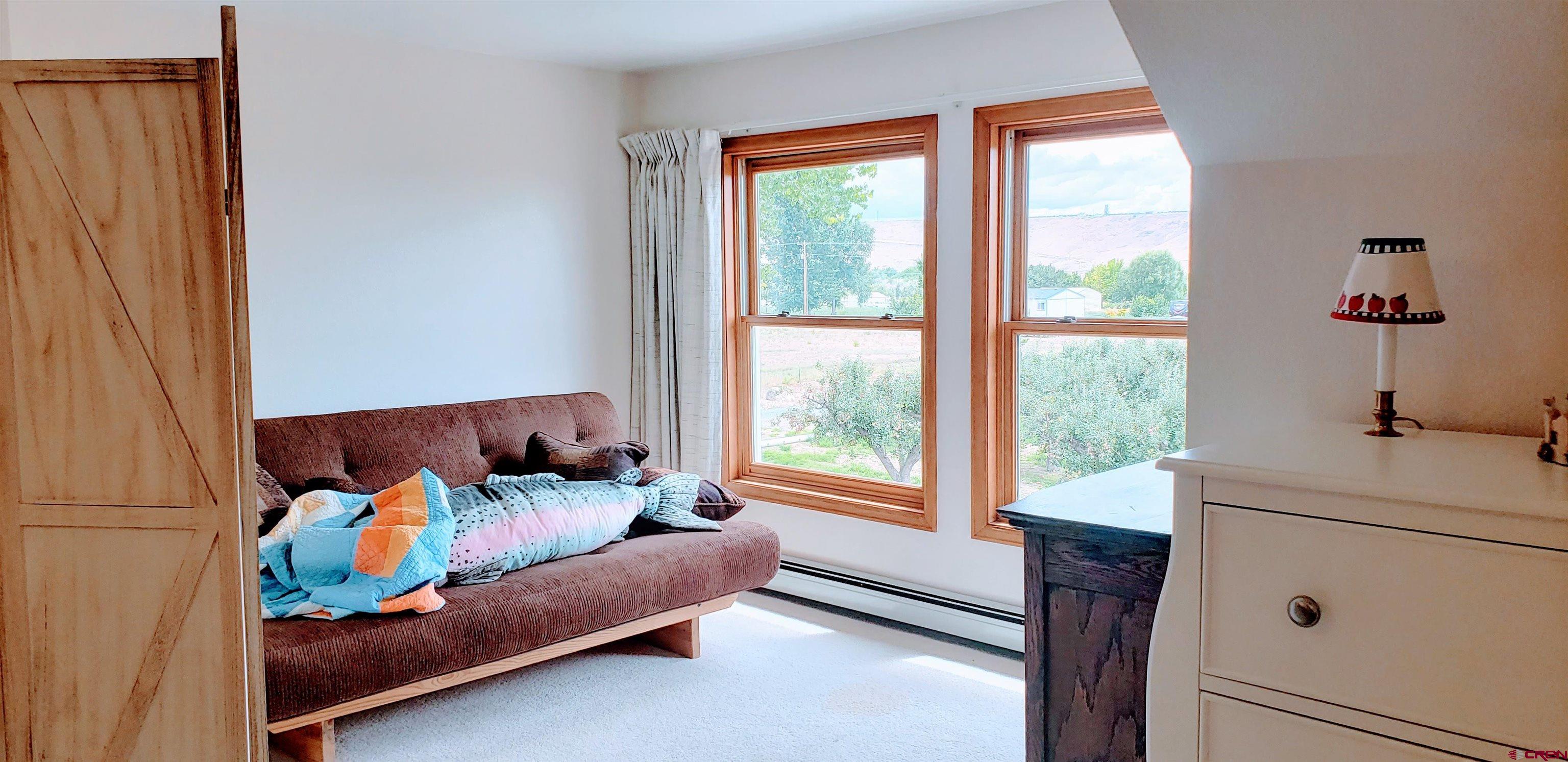 21669 Myers Road Orchard City, CO 81418 - Photo 22 of 35 a living room with furniture and a window