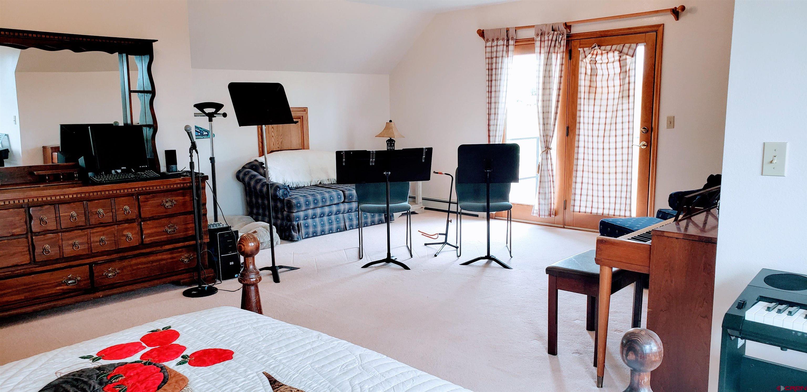 21669 Myers Road Orchard City, CO 81418 - Photo 23 of 35 a living room with furniture a flat screen tv and a window