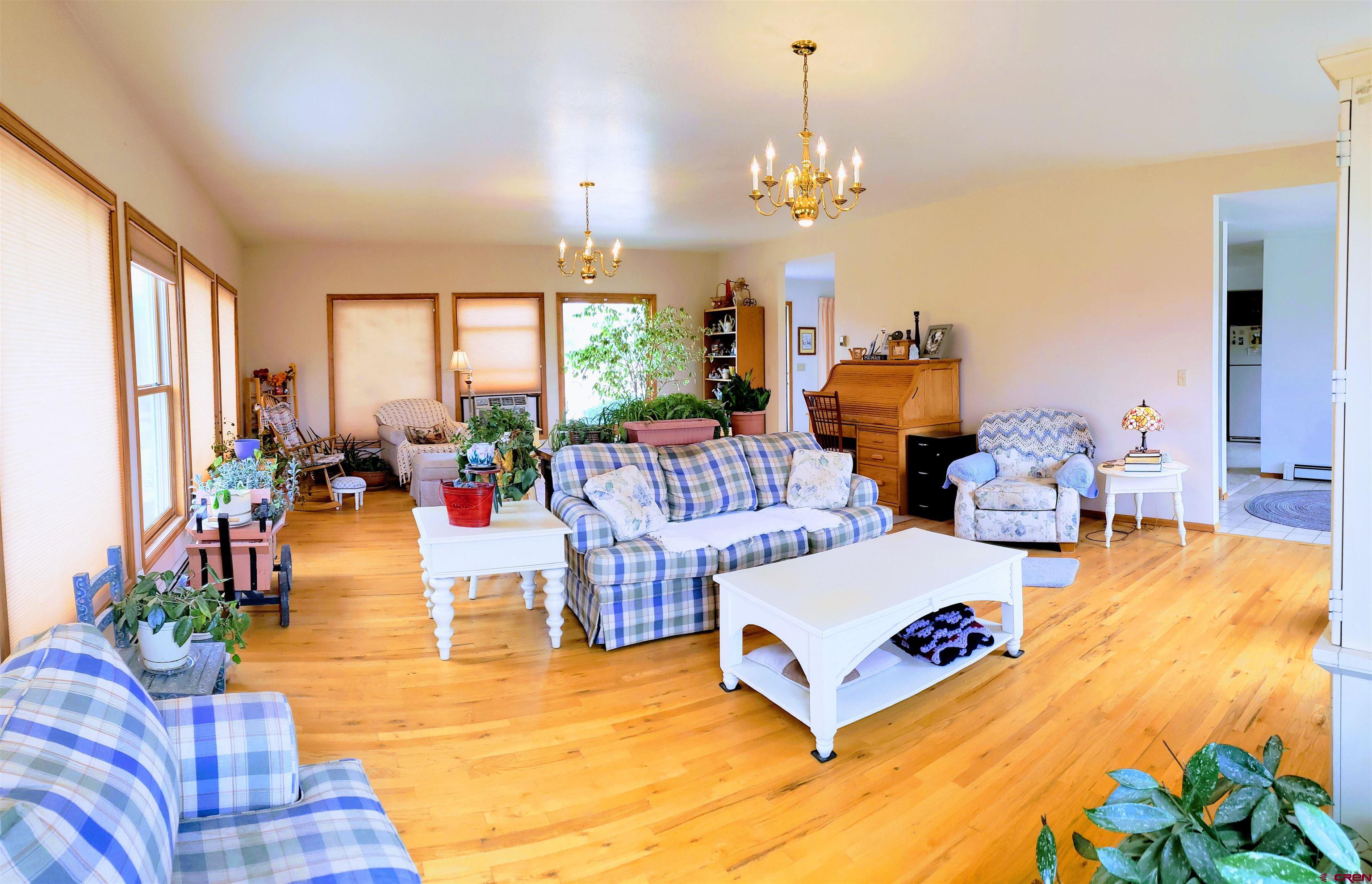 21669 Myers Road Orchard City, CO 81418 - Photo 7 of 35 a living room with furniture and a large window