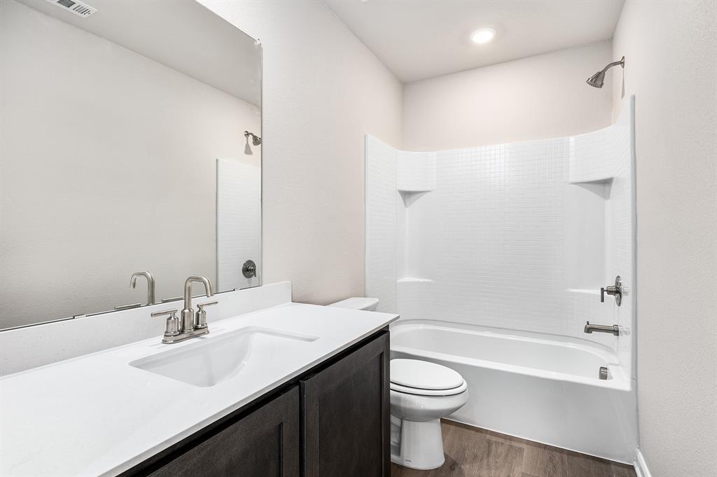 6326 Emerald Tree Lane Dallas, TX 75241 - Photo 20 of 20 a bathroom with a sink a toilet and shower