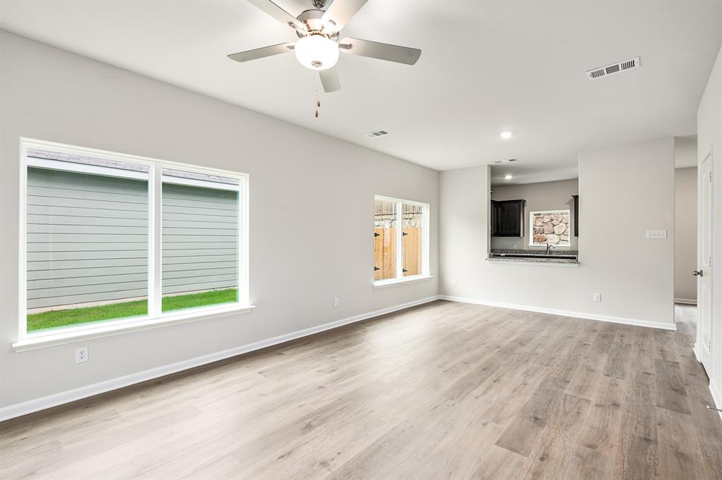 6326 Emerald Tree Lane Dallas, TX 75241 - Photo 5 of 20 a view of an empty room with a window and wooden floor