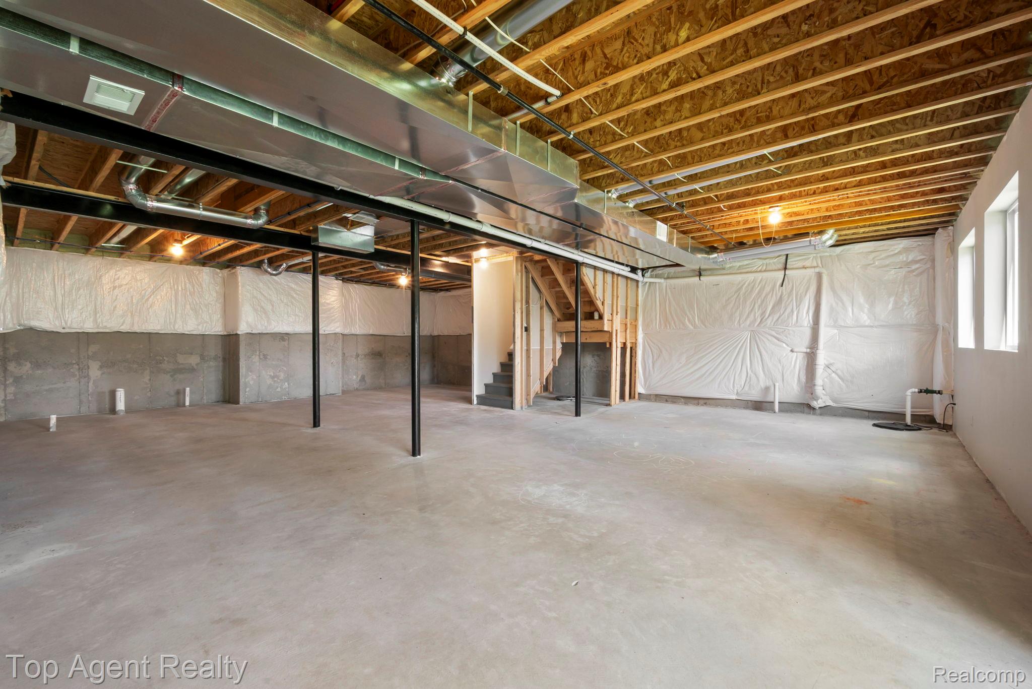 63770 Dequindre Road Washington, MI 48095 - Photo 48 of 61 Unfinished lower level with concrete flooring, exposed ceiling joists, and visible ductwork