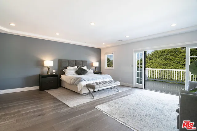 a spacious bedroom with a bed and a window