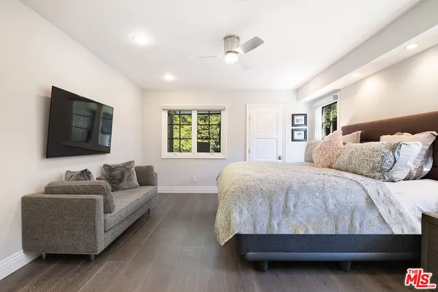 a bedroom with a bed and a couch