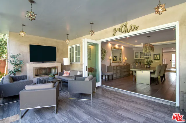 a living room with fireplace furniture and a flat screen tv