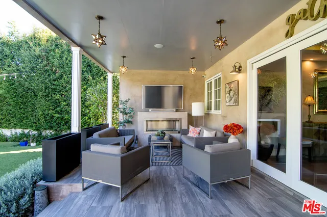 a living room with furniture potted plant and a large window