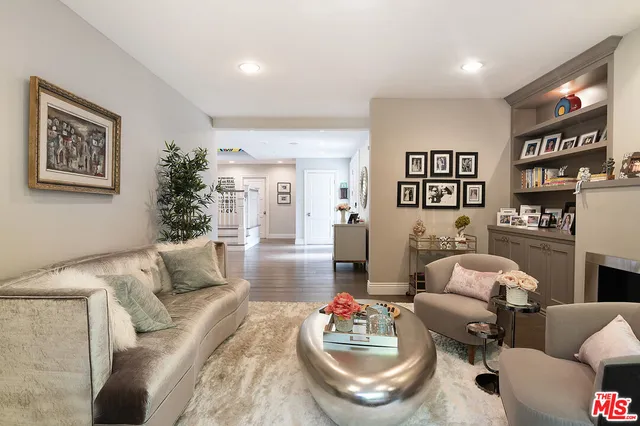 a living room with furniture and painting on the wall