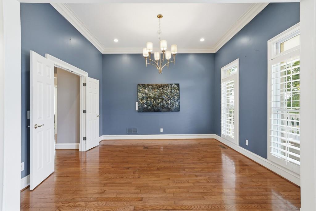774 Bray Road Southwest Calhoun, GA 30701 - Photo 12 of 106 a view of an empty room with chandelier and wooden floor