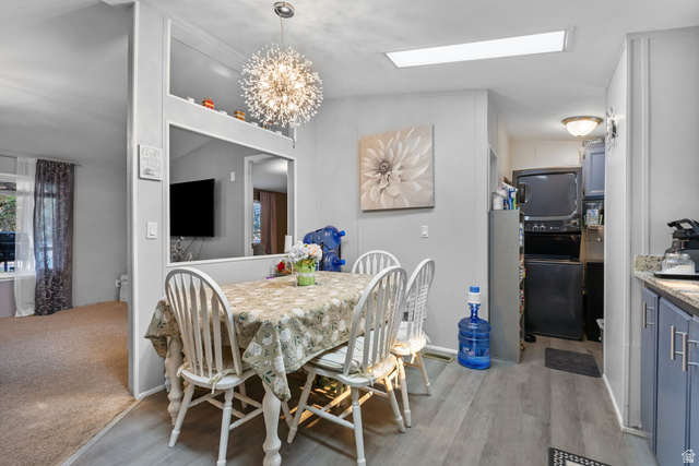 271 Mindella Way Layton, UT 84041 - Photo 9 of 27 Dining area featuring wood-finish flooring and a contemporary sputnik chandelier