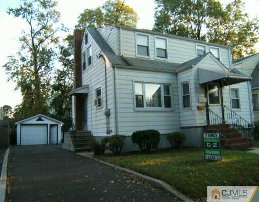 649 Front Street Dunellen, NJ 08812 - Photo 1 of 2 a front view of a house with a garden