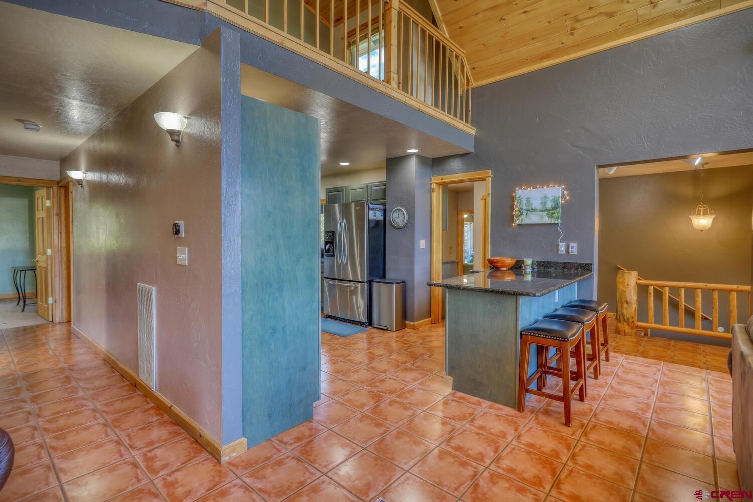 569 Eight Mile Loop Pagosa Springs, CO 81147 - Photo 11 of 31 a view of a hallway with dining room and furniture