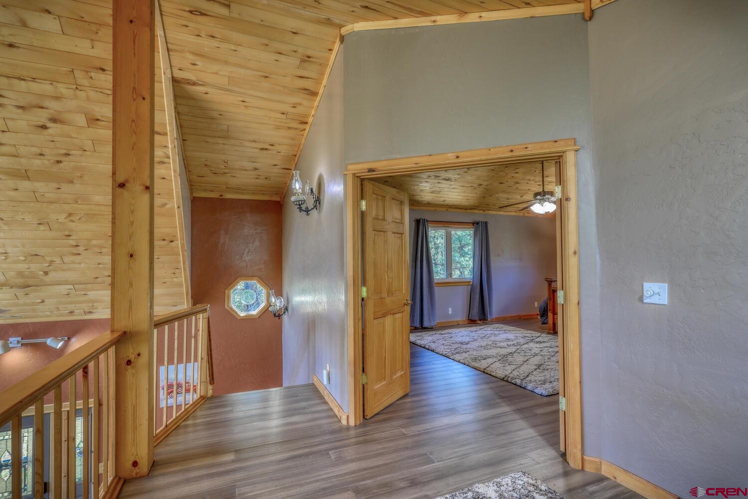 569 Eight Mile Loop Pagosa Springs, CO 81147 - Photo 14 of 31 a view of a hallway with wooden floor