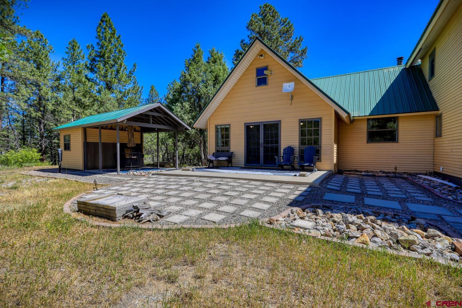 569 Eight Mile Loop Pagosa Springs, CO 81147 - Photo 4 of 31 a front view of a house with a yard