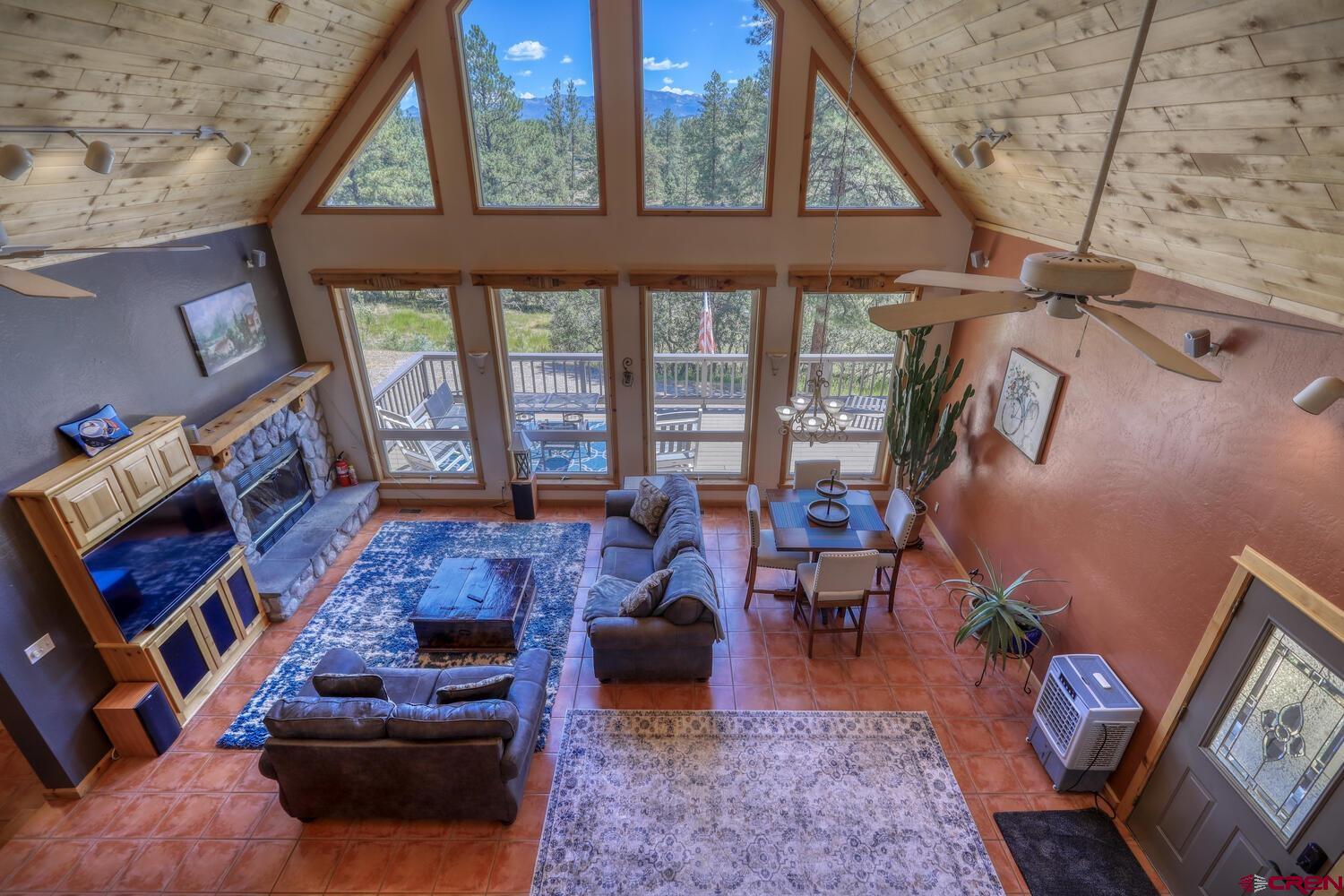 569 Eight Mile Loop Pagosa Springs, CO 81147 - Photo 6 of 31 a living room with furniture and a floor to ceiling window
