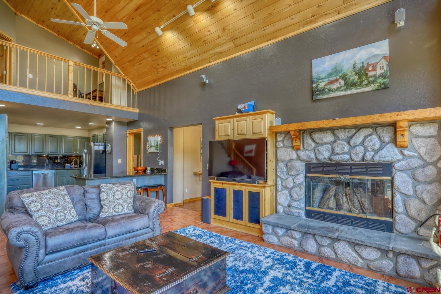 569 Eight Mile Loop Pagosa Springs, CO 81147 - Photo 7 of 31 a living room with furniture and a fireplace