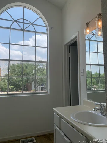 a view of a backyard with wooden floor and bench