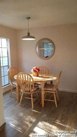a dining room with furniture and window
