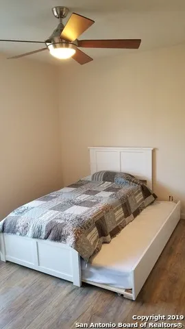 a bedroom with a bed and a night stand