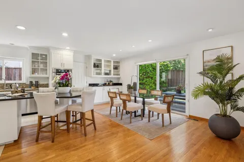 a kitchen with stainless steel appliances granite countertop a refrigerator and a table