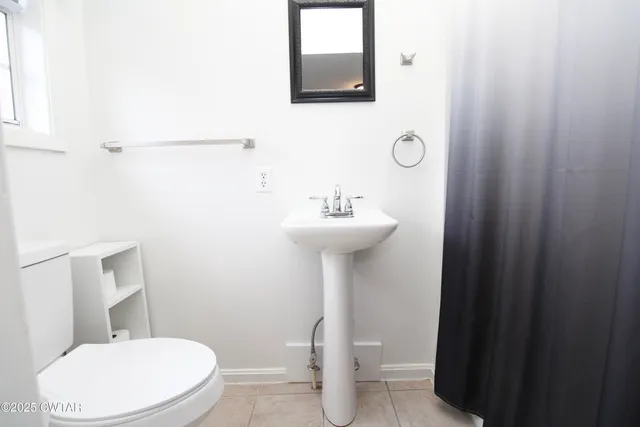 a bathroom with a sink a toilet and mirror