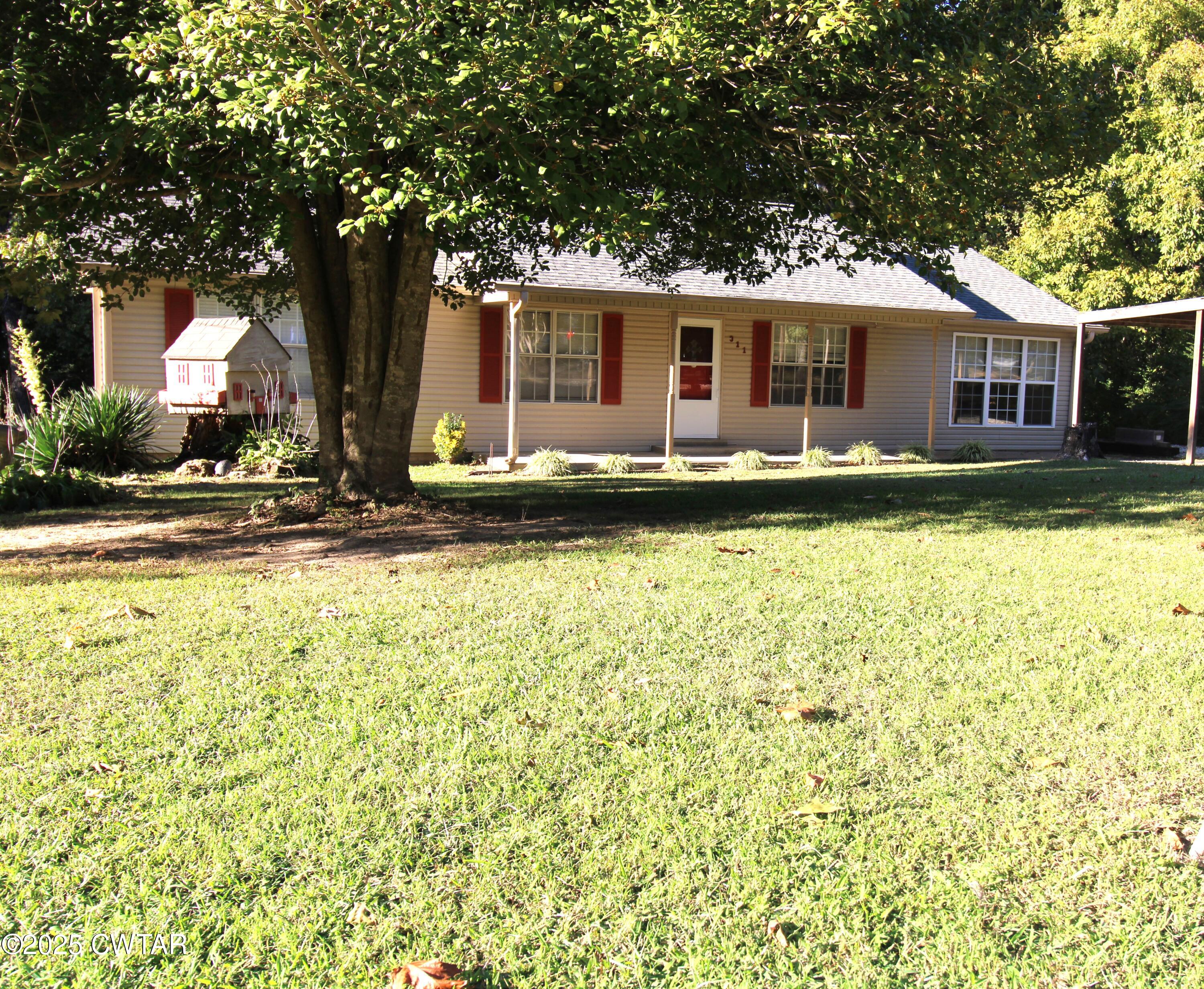 311 Elizabeth Circle Lexington, TN 38351 - Photo 15 of 23 a view of a house with swimming pool and a tree