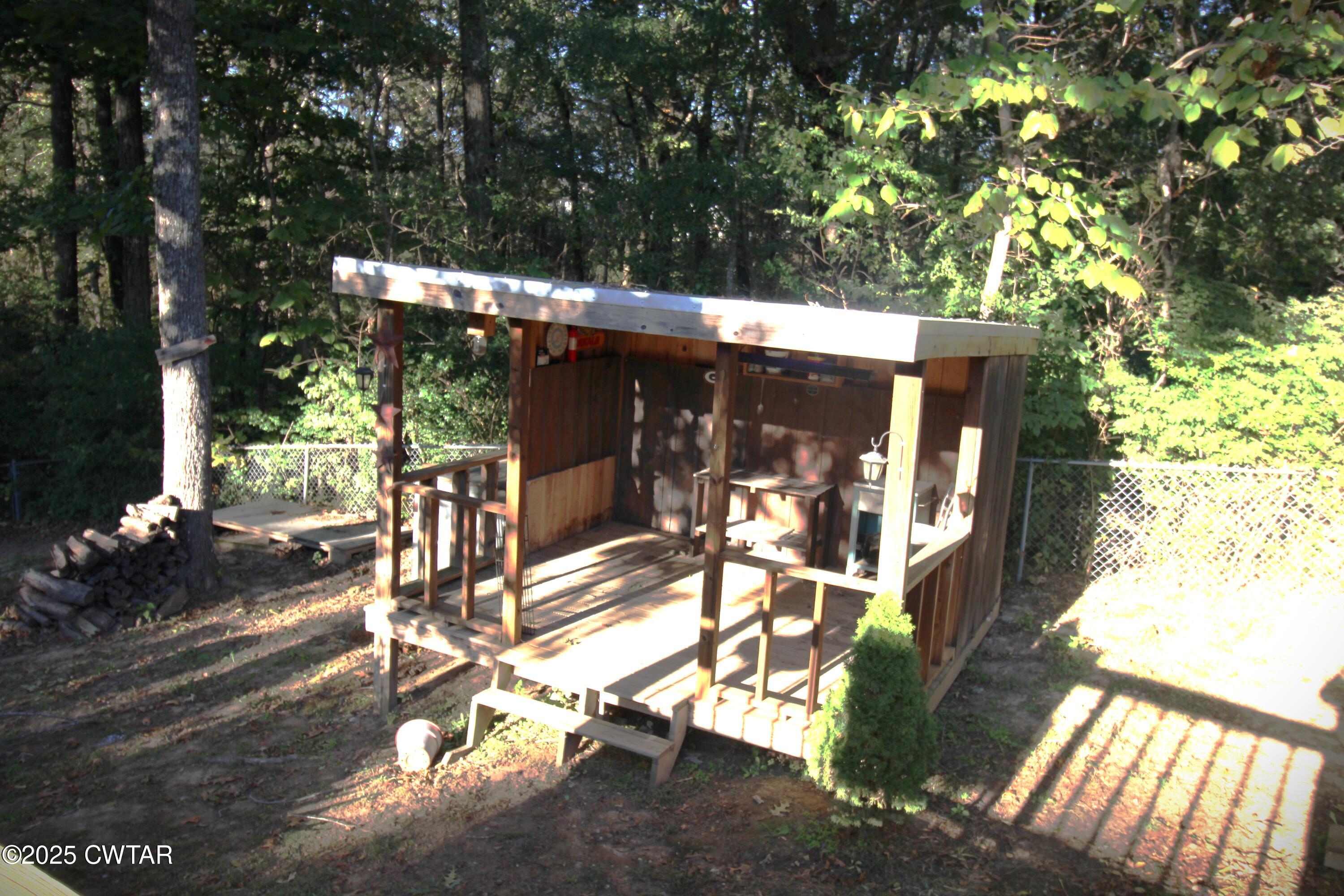 311 Elizabeth Circle Lexington, TN 38351 - Photo 16 of 23 a view of patio with table and chairs and potted plants