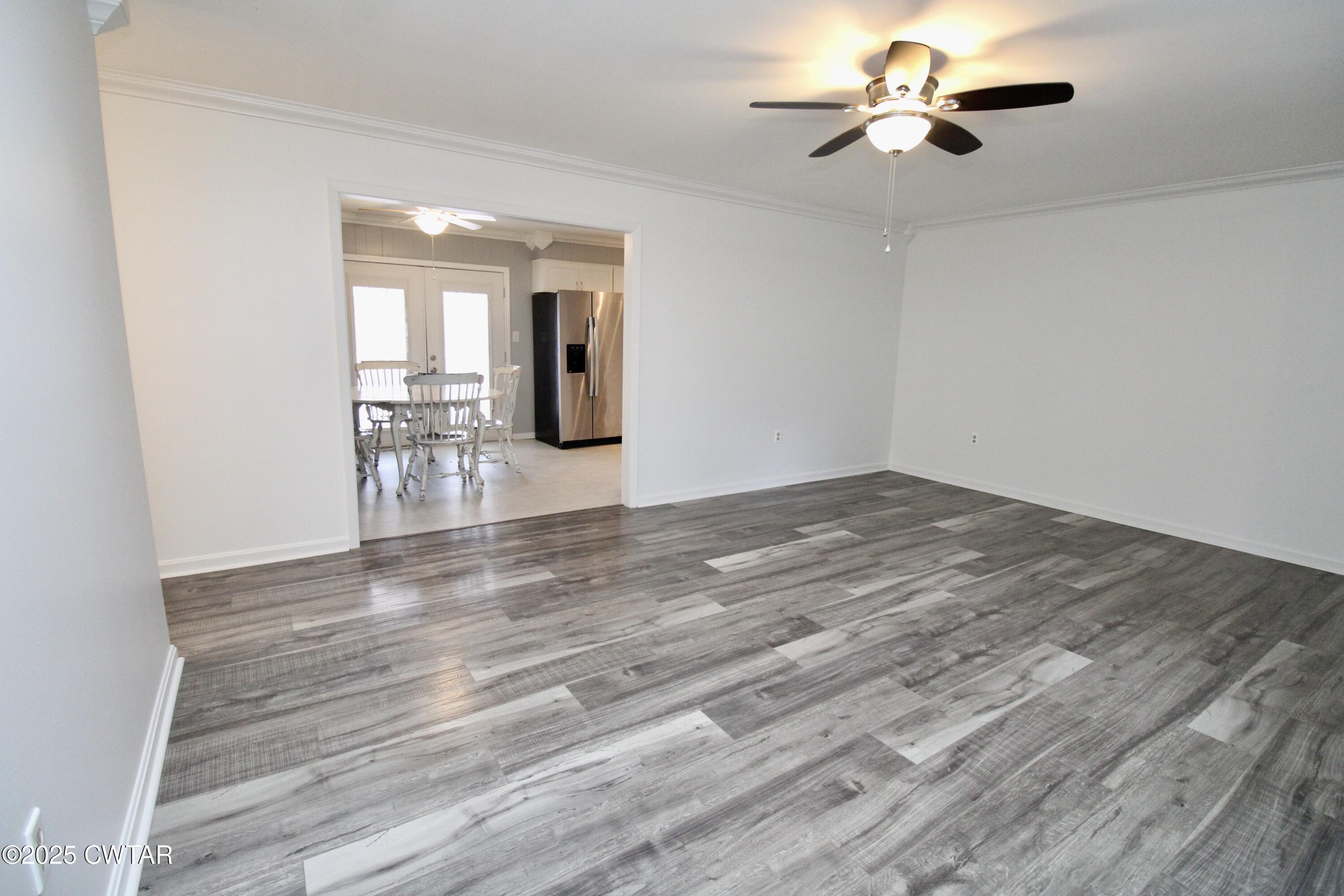 311 Elizabeth Circle Lexington, TN 38351 - Photo 3 of 23 a view of a livingroom with a chair and wooden floor
