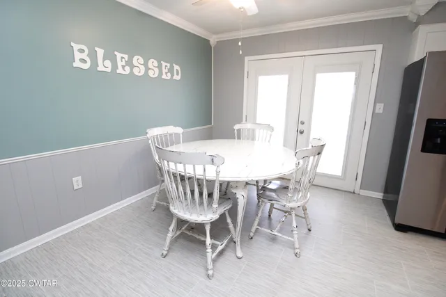 a view of a dining room with furniture and a kitchen
