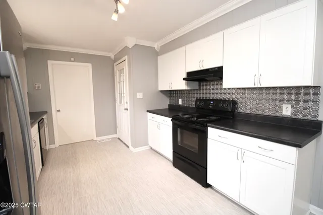 a kitchen with granite countertop a stove and a refrigerator