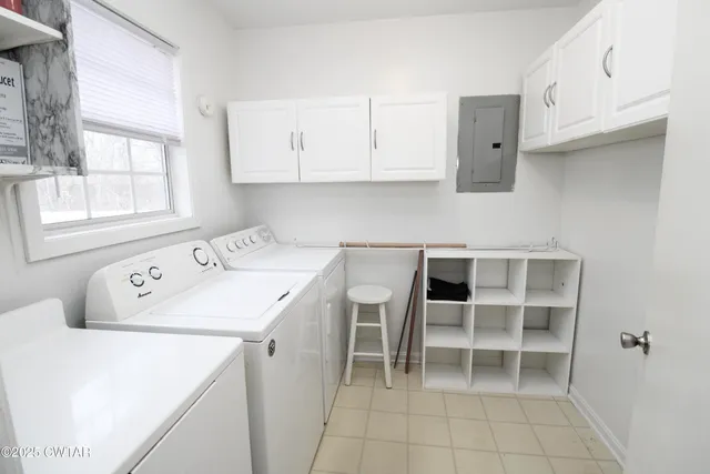 a utility room with cabinets washer and dryer