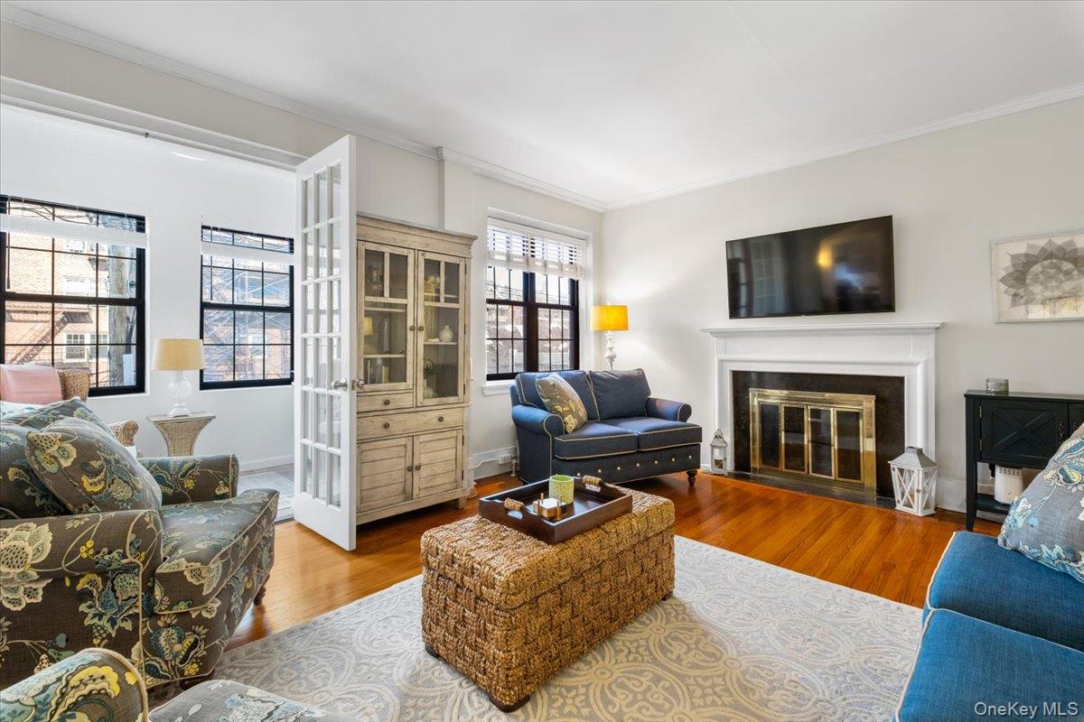 824 Bronx River Road, Unit 3A Bronxville, NY 10708 - Photo 1 of 26 Welcoming Living Room has wood burning fireplace. French Style glass doors are to at home office bonus space