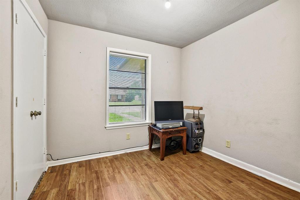 606 Hunter Street Bonham, TX 75418 - Photo 7 of 15 a view of room with window and wooden floor