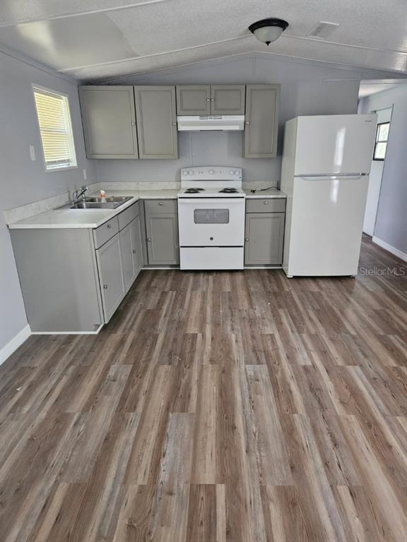 6332 West Homosassa Trail Homosassa, FL 34448 - Photo 4 of 13 a kitchen with a sink a stove top oven and white cabinetry
