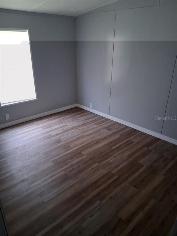 6332 West Homosassa Trail Homosassa, FL 34448 - Photo 7 of 13 a view of an empty room with wooden floor