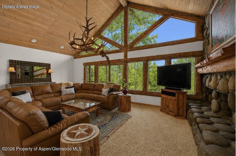 a living room with furniture a flat screen tv and a floor to ceiling window