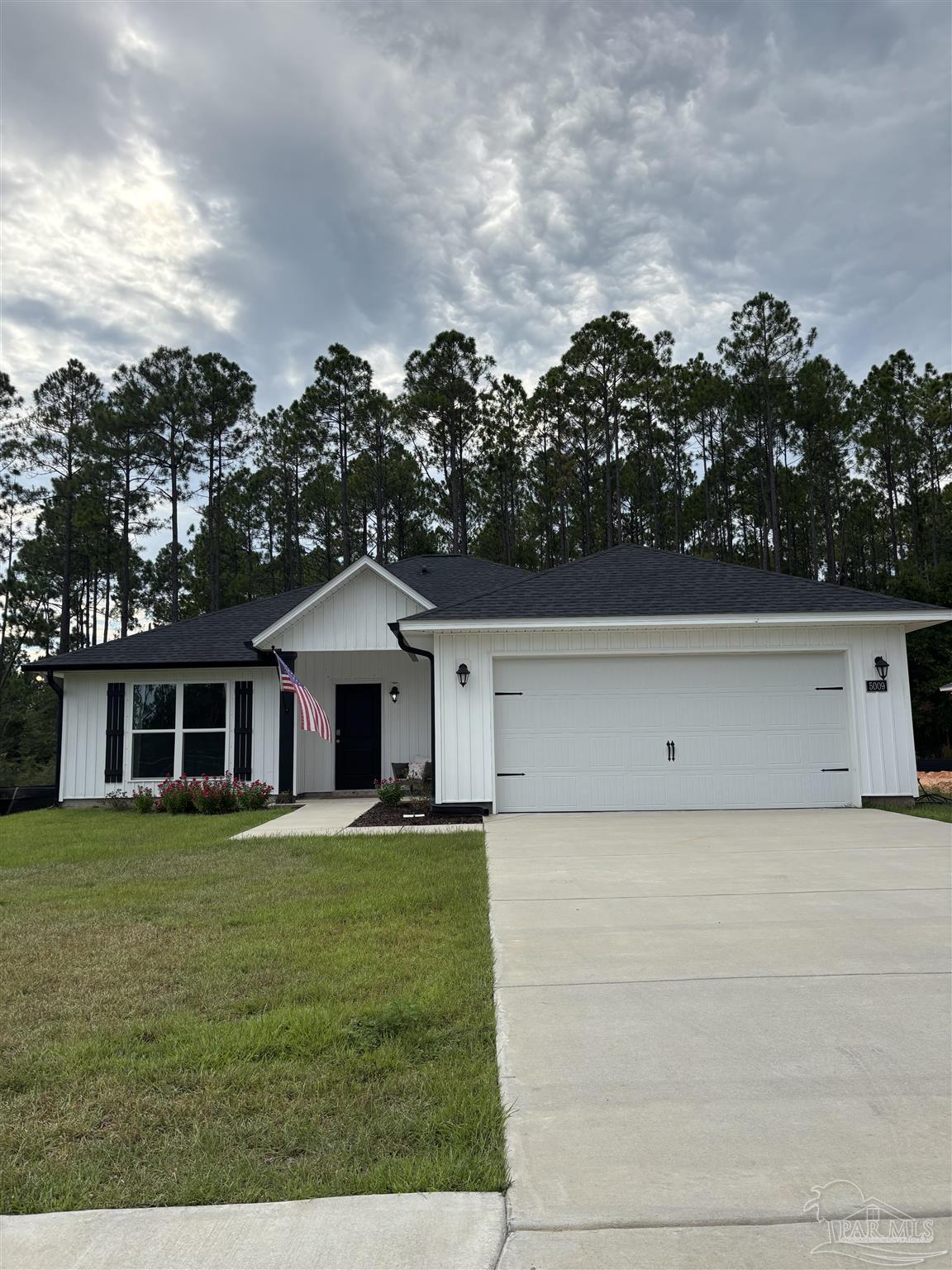 5009 Rainwater Road Milton, FL 32583 - Photo 1 of 18 a view of a house with a yard and sitting area