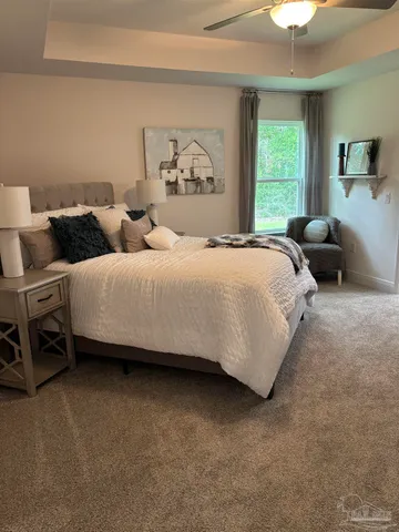 a bedroom with bed and a chandelier