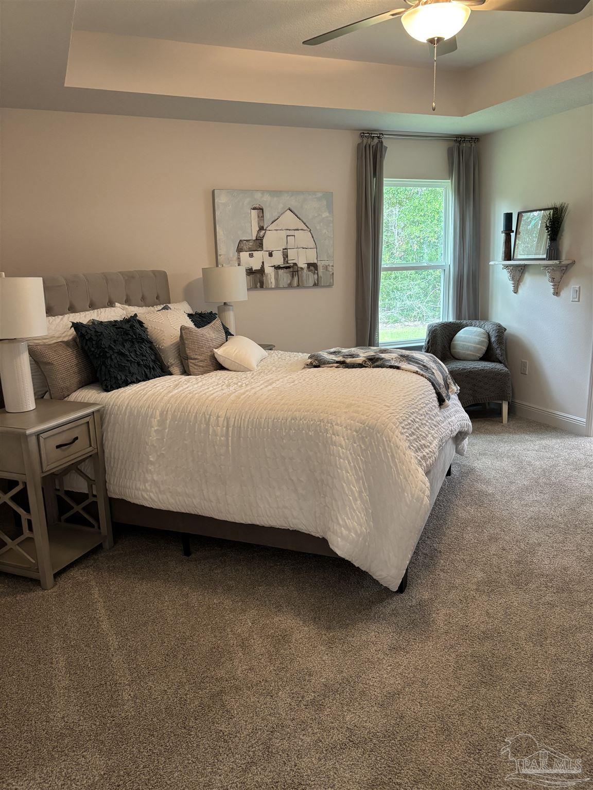 5009 Rainwater Road Milton, FL 32583 - Photo 3 of 18 a bedroom with bed and a chandelier