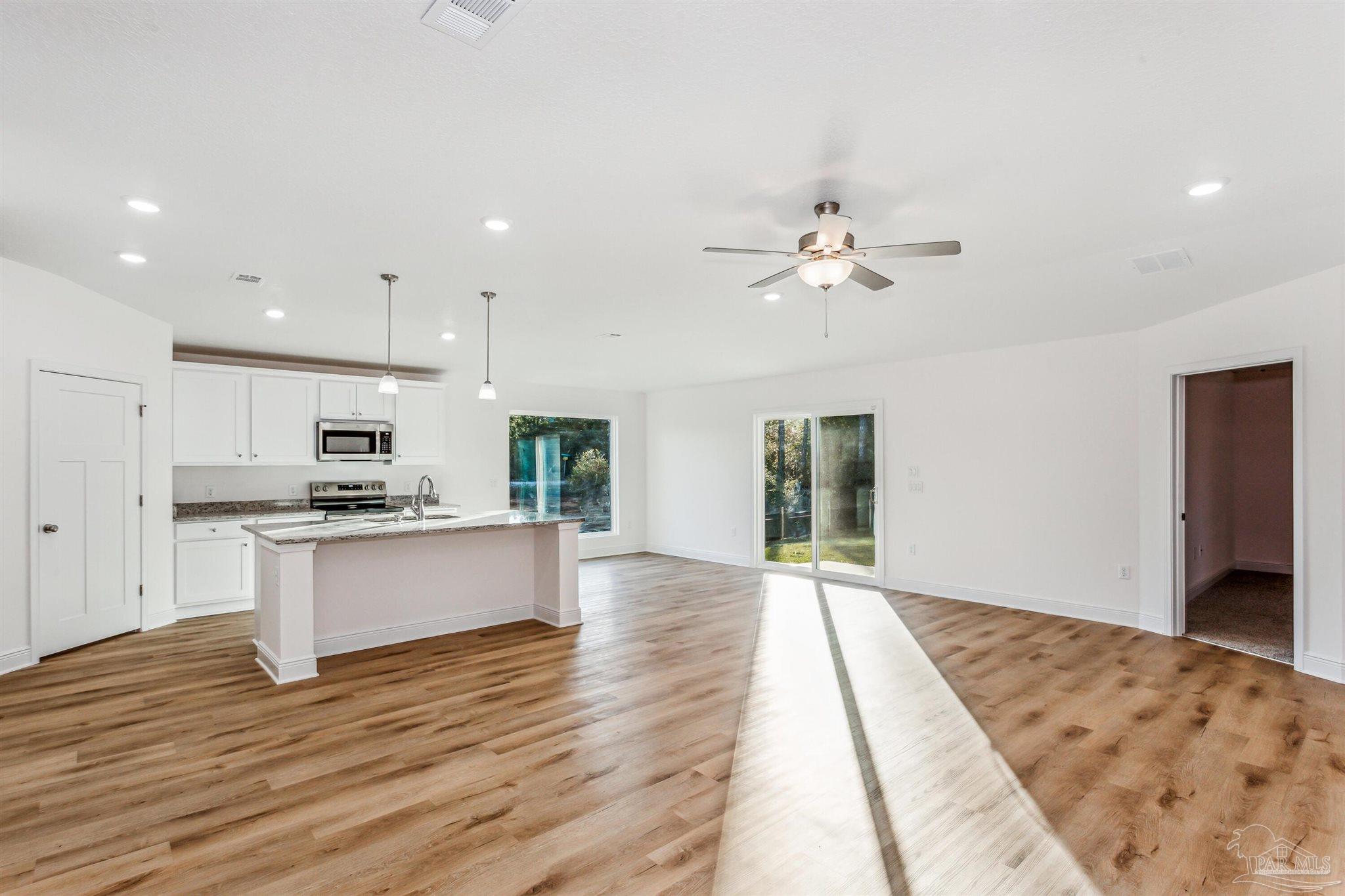 5009 Rainwater Road Milton, FL 32583 - Photo 8 of 18 a view of kitchen with sink microwave refrigerator and stove