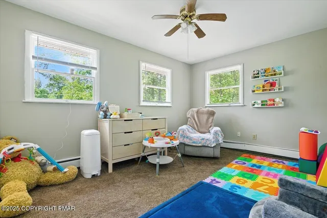a view of a room with gym equipment and wooden floor
