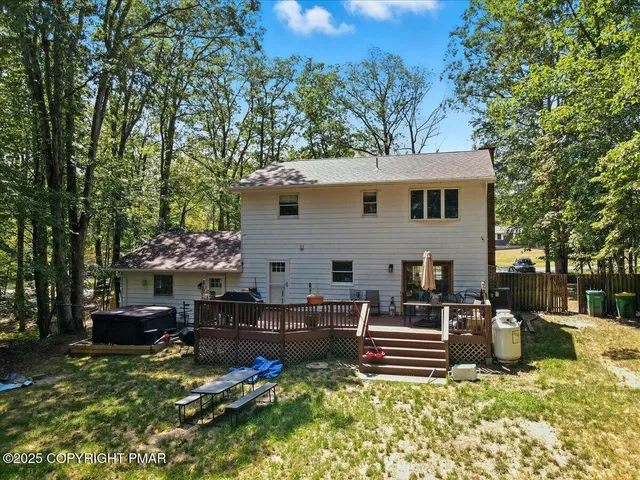 a view of a patio with chairs and potted plants